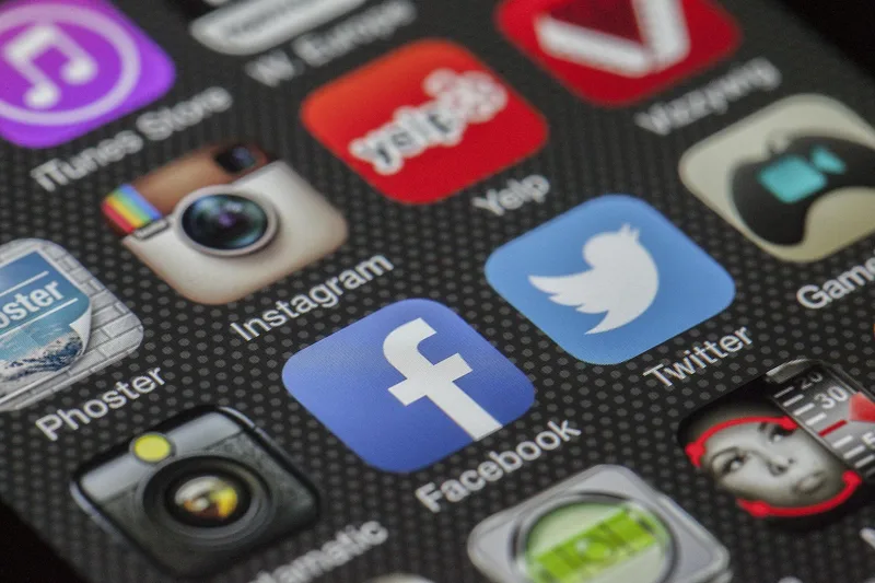 Social media apps on a smartphone screen for contacting Shopee Indonesia customer care