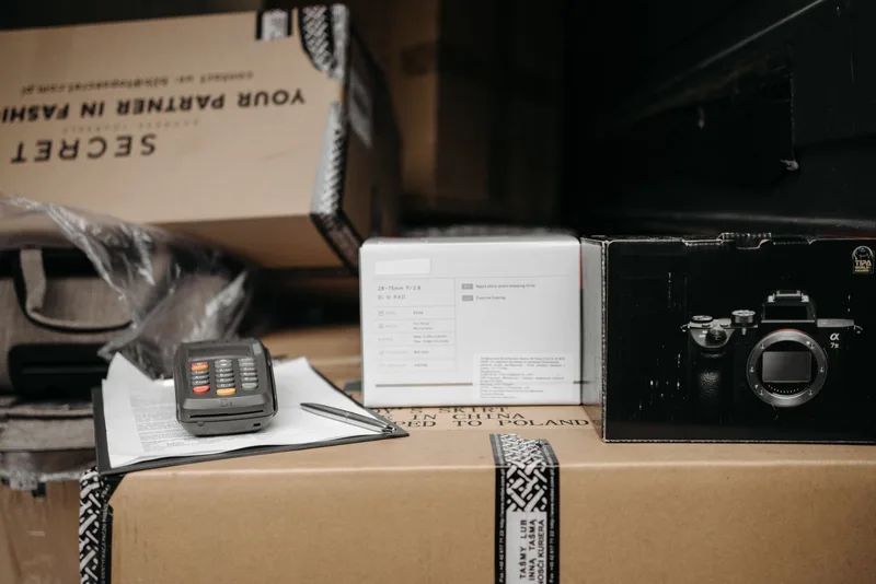 Indonesian seller packing marketplace orders with Tokopedia shipping labels on desk